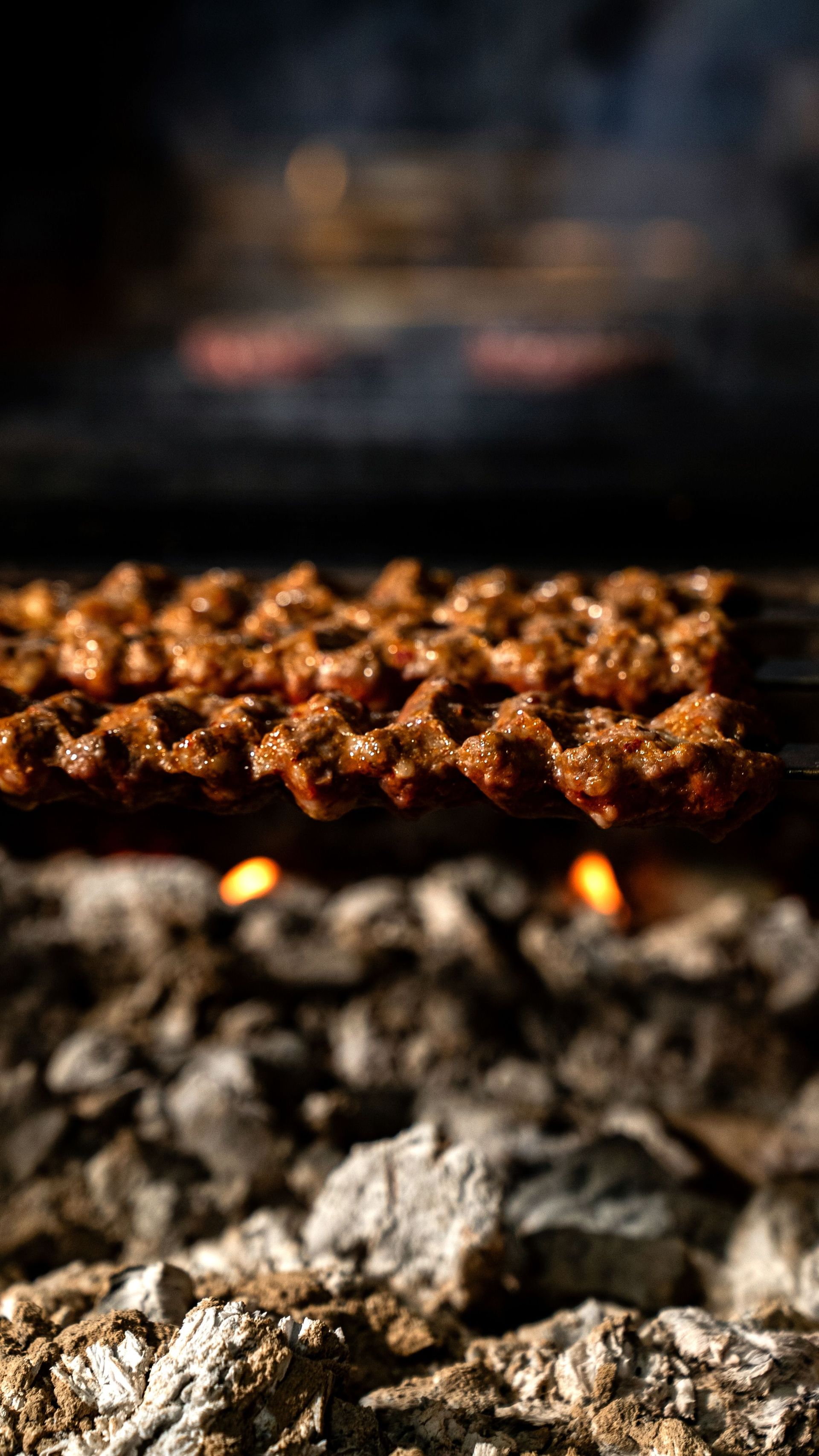 Succulent kebabs grilling over hot charcoal, a perfect BBQ scene.