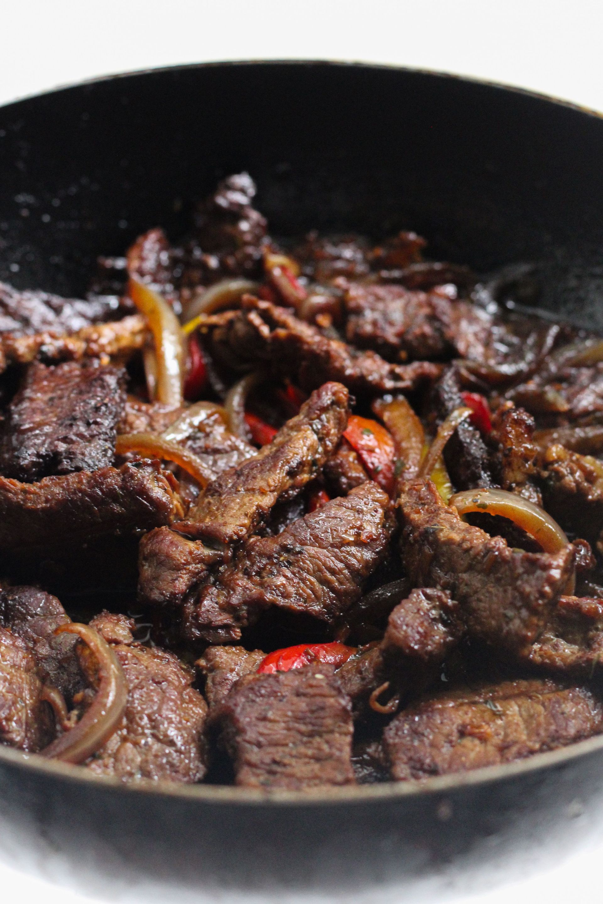 Perfectly cooked beef strips with onions and peppers for a savory meal.