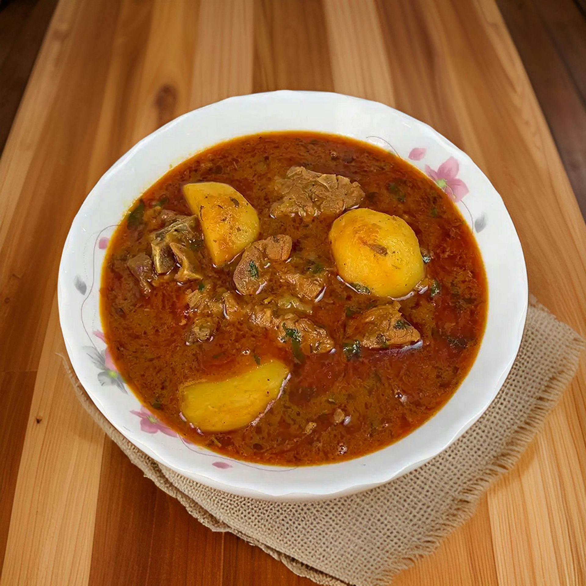 a bowl of stew on a wooden table